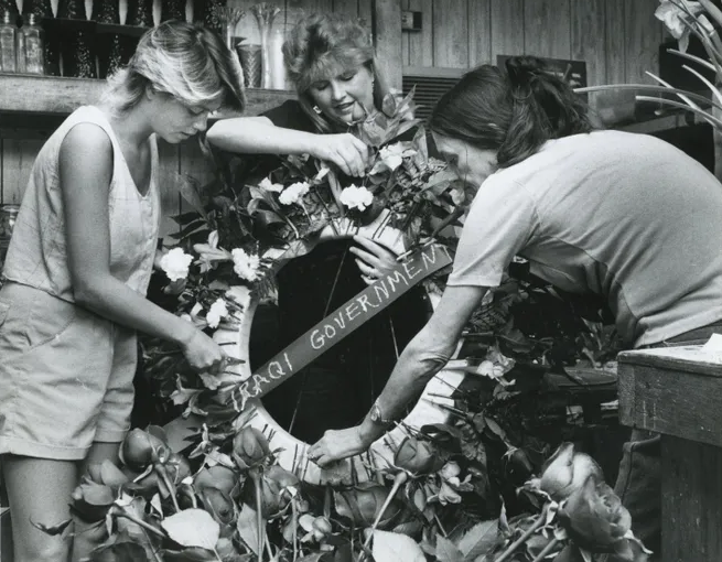 May 1987: Atlantic Beach florist Mary Deal received a strange request in May 1987. The Iraqi government wanted to send a bouquet to memorial 
                            services for the 37 crewman killed. Deal and two others are putting the finishing touches in this image.