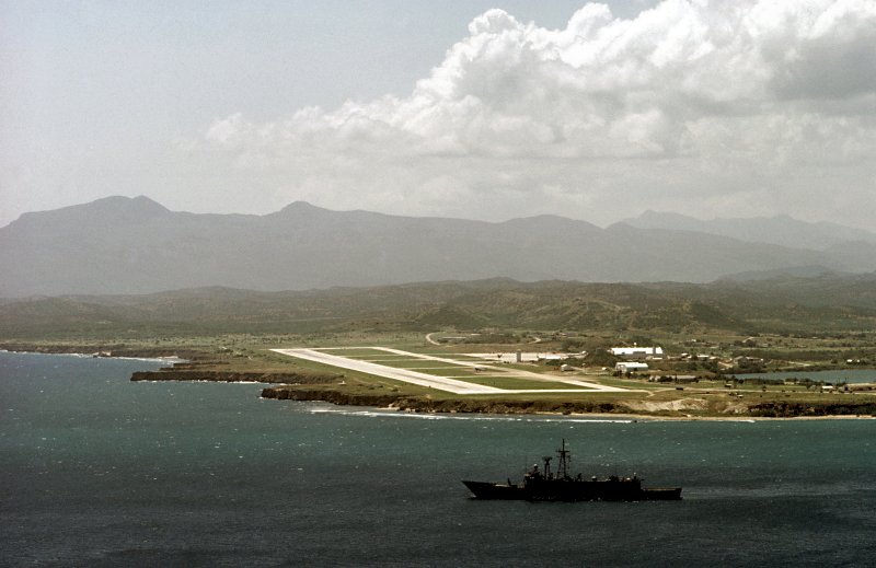 15 September 1983: The Caribbean Sea - Stark passes Naval Base Guantanamo Bay as it heads out to sea for a day of training.
