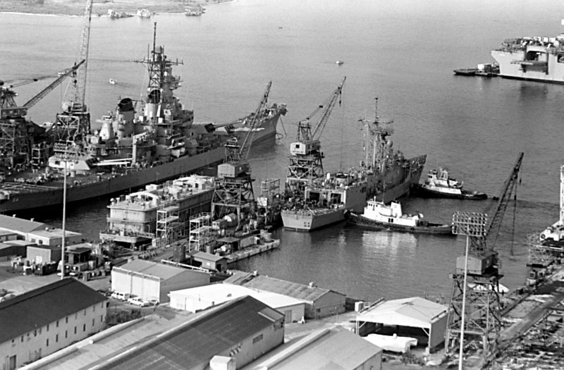 28 August 1988: Pascagoula, MS - Harbor tugs maneuver Stark toward the dock at Ingalls Shipbuilding after the ship underwent repairs 
                            for damage sustained when it was struck by two Iraqi-launched Exocet missiles while on patrol in the Persian Gulf. The battleship Wisconsin (BB64), which will undergo sea trials, is visible to 
                            the left of Stark.