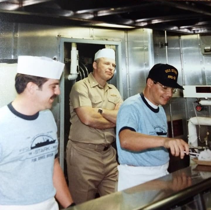 CAPT Brindel making sure the Officers perform their 'mess duties' for the crew