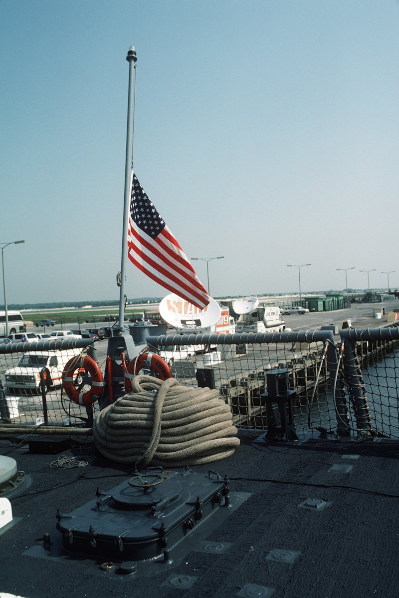 17MAY88 USS Antrim FFG-20: The US flag is lowered to half mast in honor of the 37 sailors lost aboard the USS Stark.